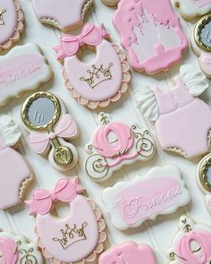 pink and white decorated cookies with princess designs on them for a baby girl shower or birthday party