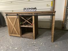 a wooden table with a sign that says southern market on it and wine bottles in the bottom drawer