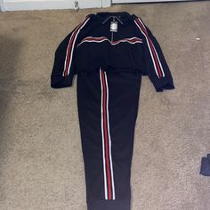 2piece Jogger Set Black And It’s Stripes Of Red, White, And Black On Sleeves And On Side Seams Of Jogging Pants. Jacket Is Pull Over With Half Zipper, As Well As Being A Cropped Top Jacket Casual Black Pant Set For Loungewear, Casual Black Pant Set For Spring, Black Matching Set With Long Sleeves, Black Long Sleeve Matching Set, Spring Black Tracksuit For Loungewear, Trendy Black Two-piece Bottoms, Casual Black Two-piece Set, Purple Joggers, Black Lounge