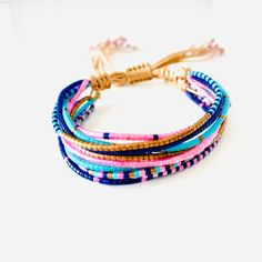 multicolored bracelets with tassels on white background