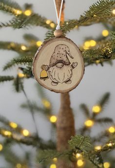 a wooden ornament hanging from a christmas tree