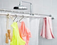 three towels hanging on a rack in a bathroom