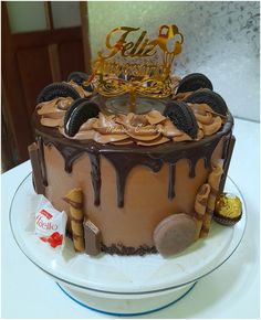 a birthday cake with chocolate icing and cookies