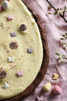 a cookie with white frosting and candies on it