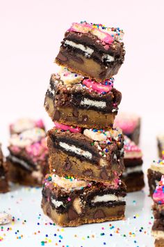 a stack of brownies with sprinkles and frosting