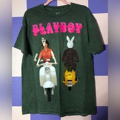 New Without Tags Officially Licensed Shirt On Quality Green Shirt With Distressed Coloring And Contrast Stitching. I Believe It’s Mid Weight Graphic Is Of The Playboy June 1959 Cover Of A Bunny And Woman Passing Each Other On Motorbikes. This Shirt Is A Misprint - The Graphic Was Printed On Front And Back, And On The Front Was Double/Triple Printed Creating A Ghostly Duplicative Effect. There Are Also Touches Of Color Across The Shirt From The Misprint (A Little Red On The Shoulder, Little White Retro Letter Print Tops By Urban Outfitters, Urban Outfitters Retro Letter Print Tops, 90s Style Green T-shirt For Spring, Spring Fun Streetwear Shirt, Fun Spring Streetwear Shirt, Urban Outfitters T-shirt For Spring Streetwear, Trendy Cotton T-shirt By Urban Outfitters, Vintage Green Top With Funny Print, Green Vintage Top With Funny Print