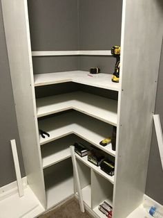 the corner shelves are built into the wall to create a storage area for tools and other items