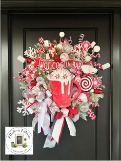 a christmas wreath with candy canes, marshmallows and hot chocolate on it