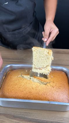 a person is cutting into a cake with a spatula on the top of it