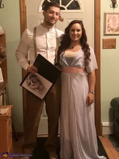 a man and woman are standing in front of a door wearing costumes from the movie beauty and the beast