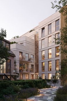 an apartment building with many windows and landscaping