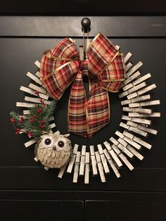 a wreath made out of clothes pegs and an owl