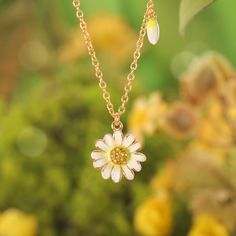 Step into a world of whispered secrets and timeless charm with the Daisy Pendant Necklace, part of our Nature Jewelry collection. Meticulously handcrafted in 18K gold-plated brass, the delicate enamel daisy sparkles with cubic zirconia accents, a nod to the Victorian Era’s love for symbolism. Back then, daisies weren’t just flowers—they represented innocence, loyalty, and the sacred duty of keeping confidences. Gifting a daisy meant, in the silent language of flowers, “your secret is safe with m Yellow Gold Enamel Flower Jewelry, Dainty Brass Flower Pendant Jewelry, Handmade Yellow Gold Enamel Necklaces, Handmade Yellow Gold Enamel Necklace, Gold Plated Jewelry With Delicate Chain And Flower Pendant, Gold Plated Flower Jewelry For Anniversary, Mother's Day Gold Plated Flower-shaped Jewelry, Mother's Day Gold Plated Flower Shaped Jewelry, Mother's Day Flower Shaped Gold Plated Jewelry