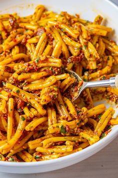 a white bowl filled with pasta covered in sauce