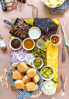 a table topped with lots of different foods and condiments on top of it