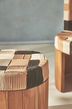 two wooden stools sitting next to each other on top of a white tile floor