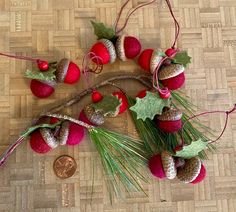 some red and green ornaments are hanging on a table next to a penny ornament