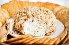 a cheese ball on a plate with crackers