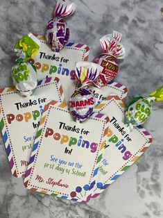 some candy bags are sitting on a table with thank you for poppin's tags