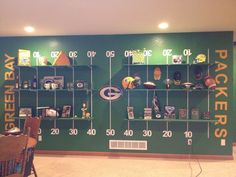 a green wall with football memorabilia on it