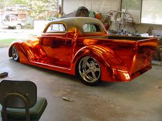 an orange car is parked in a garage