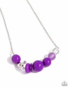 Infused with a single silver bead, an oversized collection of glassy and polished translucent and purple acrylic beads and rings are threaded along an invisible wire below the collar for a flamboyant fashion. Features an adjustable clasp closure. Sold as one individual necklace. Includes one pair of matching earrings. Purple Large Beaded Necklace, Purple Glass Beads For Jewelry Crafting, Purple Glass Jewelry For Jewelry Making, Modern Purple Jewelry For Party, Purple Necklace With Adjustable Chain, Adjustable Purple Beaded Necklaces With Large Beads, Adjustable Purple Beaded Necklace With Large Beads, Adjustable Purple Necklaces, Adjustable Purple Necklace