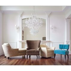 a living room filled with furniture and a chandelier