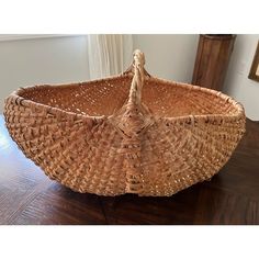 a woven basket sitting on top of a wooden table