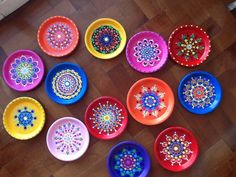 many colorful bowls are arranged on the floor