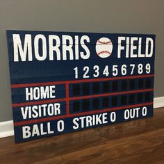 a wooden sign that says morris field home visitor ball strike out