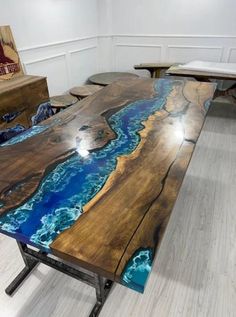 the table is made out of wood and has blue paint on it's surface