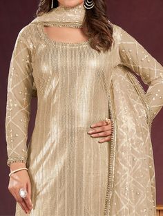 Introducing a charming beige net kameez adorned with delicate threadwork, sequin detailing, and fancy readymade lace border, creating an ensemble that exudes elegance. Paired seamlessly with a crepe salwar in a matching beige shade, this outfit is a perfect blend of sophistication and style.
Completing the ensemble is a net dupatta in a similar beige color, featuring sequin work, thread embroidery, and a fancy lace border.
The beige salwar kameez comes as an un-stitched material, accommodating s Beige Semi-stitched Sharara For Eid, Party Wear Beige Georgette Sharara, Beige Georgette Sharara For Party, Beige Anarkali Sharara For Party, Festive Beige Churidar, Gold Bollywood Unstitched Floor-length Suit, Gold Bollywood Floor-length Unstitched Suit, Beige Sharara With Dupatta For Party, Bollywood Style Cream Sharara For Party