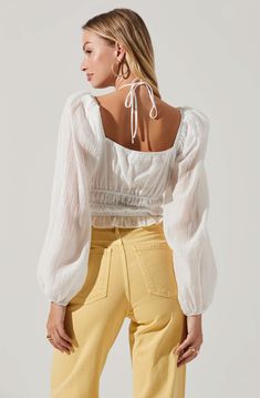 The Irwin Top features a lightweight and breezy finish. Halter neckline leads to a cutout detail at the bust. Smocked bodice. Long, puff sleeves with elastic cuffs. Cropped. Halter Neck Tops, Puff Sleeve Tops, Travel Chic, Halter Neck Top, Long Puff Sleeves, Puff Sleeve Top, Halter Neckline, Chic Boutique, S Models