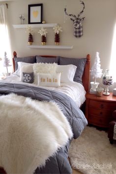 a bed room with a neatly made bed and two deer head mounted on the wall