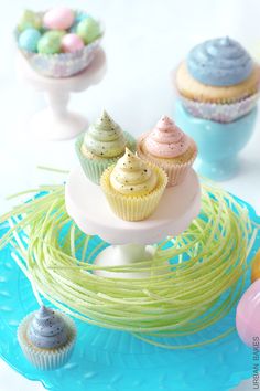 some cupcakes are sitting on a cake stand