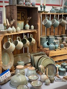 a table topped with lots of dishes and cups