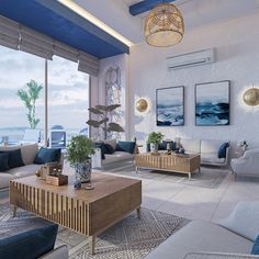 a living room filled with furniture next to a large window overlooking the ocean on top of a hill