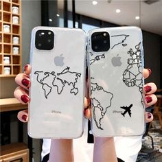 two people holding up their iphone cases with the world map on them