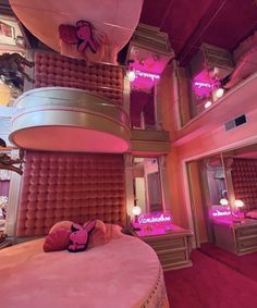 the inside of a bedroom with pink lighting