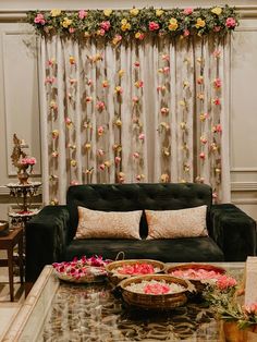 a living room filled with furniture and flowers on the wall