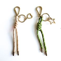 two keychains made out of wood and rope, one with a star on it