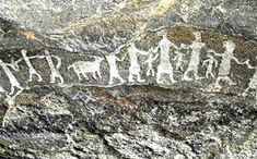 an image of some kind of rock with animals and people painted on it's side