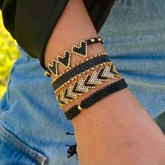 a person wearing two different bracelets on their arm