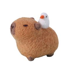 a stuffed animal with a small white bird on top of it's back end