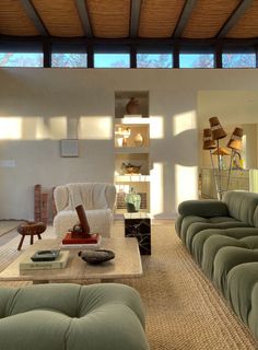 a living room filled with furniture and a large window over the top of it's roof