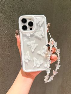 a person holding a phone case with butterflies on it