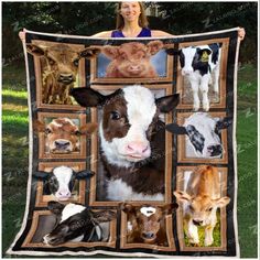 a woman holding up a blanket with pictures of cows on it