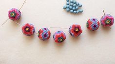 beads and pins are arranged on a table