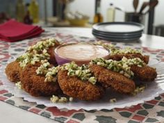 fried food on a plate with dipping sauce