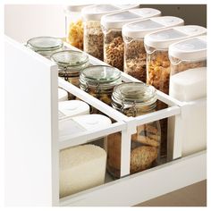 the drawers are filled with various containers and food items, including breadcrumbs